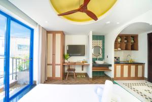 a bedroom with a bed and a desk in a room at Sujet Hotel Da Nang in Danang
