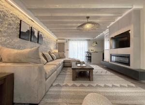 a living room with a couch and a table at Tudor Cottage, Hot Tub, Sleeps 8 in Llandudno