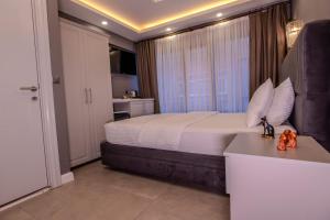 a bedroom with a bed with white sheets and a window at Classio Hotel Kadıköy in Istanbul