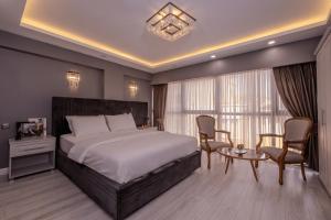 a bedroom with a bed and a table and chairs at Classio Hotel Kadıköy in Istanbul