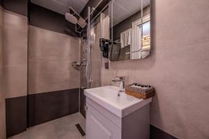 a bathroom with a sink and a shower at Classio Hotel Kadıköy in Istanbul