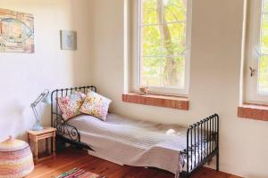 a small bed in a room with a window at dALL in Śmidzięcino