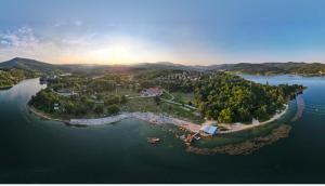 an island in the middle of a large body of water at Vila Tea Borsko Jezero in Bor