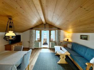 a living room with a blue couch and a table at Ferienwohnung Grasegger in Farchant