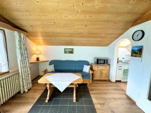 a living room with a table and a couch at Ferienwohnung Grasegger in Farchant