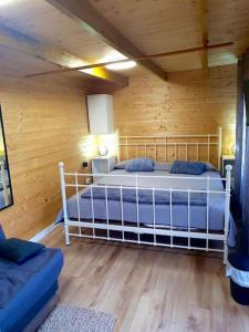 a bedroom with a bed in a wooden room at El Refugio del Valle in La Orotava