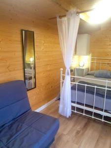 a bedroom with a bed and a mirror and a curtain at El Refugio del Valle in La Orotava +16 photos