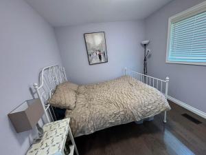 a small bedroom with a bed and a window at Willowdale in Toronto