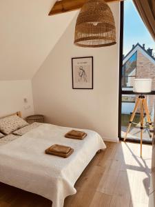 Postel nebo postele na pokoji v ubytování LENIVIEC Lubiatowo