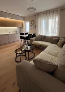 a living room with a couch and a table at Magnolia's Apartment in Yzberishti