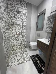 a bathroom with a toilet and a sink at villa avec piscine sans vis a vis in Temlale +3 photos