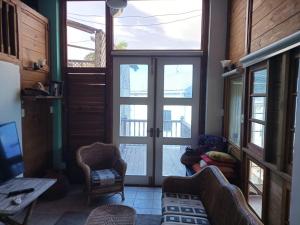 a living room with a large glass door at Paradise Point Villas in Castara