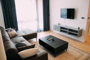 a living room with a couch and a tv at LuxDS in Tuzla
