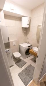 a small bathroom with a toilet and a sink at LuxDS in Tuzla