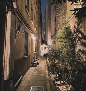 an alley with a bench in the middle of a building at New renoveted studio in calm area near nation in Paris