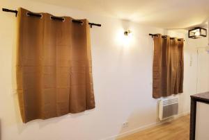 a bathroom with brown curtains on a wall at New renoveted studio in calm area near nation in Paris