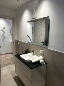 a bathroom with a sink and a mirror at Ferienwohnung Julian in Termeno