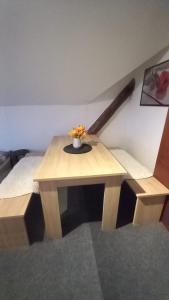 a wooden table with a baseball bat on it at Ubytování u Sýkorky in Ostrov