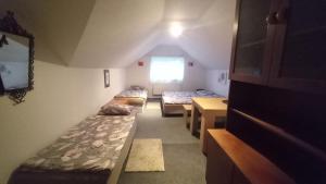 a dorm room with three beds and a window at Ubytování u Sýkorky in Ostrov