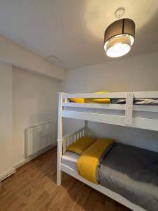 a bedroom with two bunk beds and a light at Sterling Suites Ealing in Ealing
