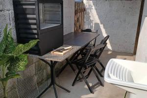a table with two chairs and a tv on a balcony at Recanto massaguaçu in Massaguassu +46 photos