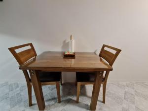 a wooden table with two chairs and a candle on it at Studio Arsenale 7 in Rovinj +19 photos