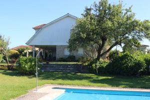 a house with a swimming pool in the yard at Chalet con piscina in Tui