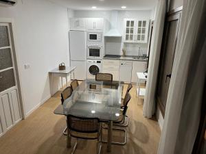 a kitchen with a table and chairs in a kitchen at Casa Lucero in Carmona