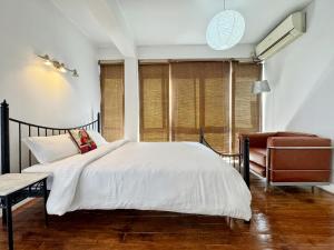 a bedroom with a bed and a chair at Ananya Apartments Phase 1 in Kathmandu