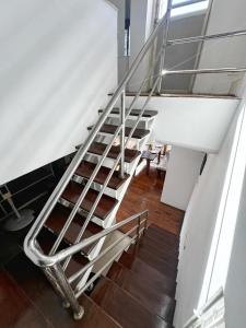 a staircase in a building with a metal railing at Ananya Apartments Phase 1 in Kathmandu