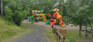 una fila de equipos de juegos en un parque en Mobil home agreable et fonctionnel, en Besse-et-Saint-Anastaise