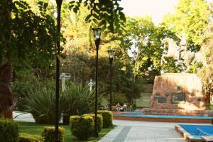 a statue of two horses jumping over a pool at Antonieta Hostel in San Rafael