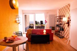 卢加诺Yellow House - Lugano的客厅里有一张红色沙发和一张桌子。