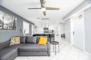 a living room with a couch and a ceiling fan at Cozy Getaway with Pool and Putting Green Unit 1 in Fort Lauderdale