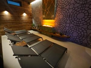 a row of chairs in a room with a wall at Wellness Penzion Jarmilka in Bedřichov