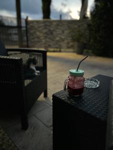 a drink in a cup sitting on top of a table at Maria’s studio in Paphos City +4 photos