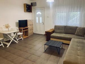 a living room with a couch and a table at Vila Andja, Apartmani i Sobe in Krašići