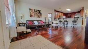 a living room with a couch and a table at Springwood Executive Home near Exxon Campus in Spring