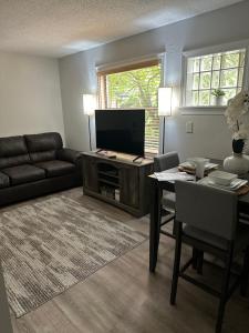 a living room with a couch and a table and a television at MDKD Private Place in Decatur
