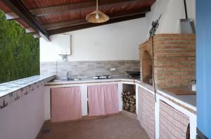 a kitchen with a sink and a brick wall at Alojamiento turístico Loma Alta in Cambil +28 photos