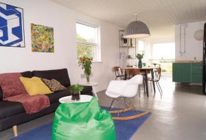 a living room with a couch and a table at Bihytten in Hejls