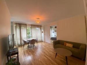a living room with a couch and a table at Jardin Cambronne Tour Eiffel in Paris