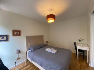 a bedroom with a bed and a table and a lamp at Jardin Cambronne Tour Eiffel in Paris
