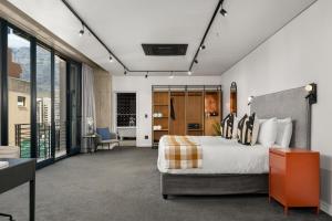 a bedroom with a bed and a room with a view at Neighbourgood Loop Street in Cape Town +34 photos