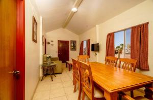 a dining room with a wooden table and chairs at Beach Bungalow, Pool and direct Beach Access in San Felipe