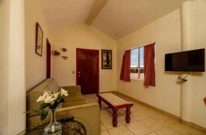 a living room with a couch and a tv at Beach Bungalow, Pool and direct Beach Access in San Felipe +19 photos