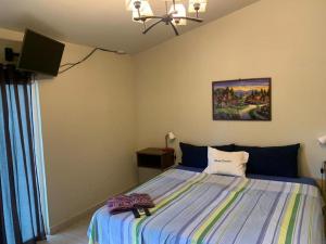 a bedroom with a bed and a television in it at Olas del mar in La Libertad