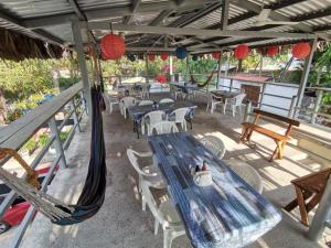 a patio with a blue table and chairs and red lanterns at Olas del mar in La Libertad