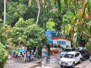 a group of people sitting around a swimming pool at Olas del mar in La Libertad