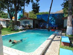 a person swimming in a swimming pool in a yard at Olas del mar in La Libertad